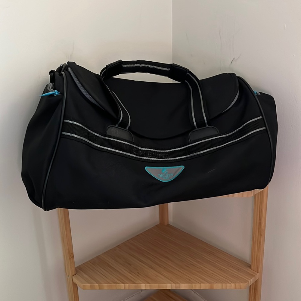 Delsey duffel bag, black with teal and grey zips. Great overnight or weekend bag